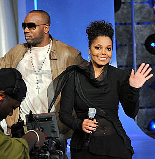 Stars of Why Did I get Married Too, Janet Jackson & Malik Yoba, Yoba has Facist Iron Cross on T-Shirt and a Christian Cross